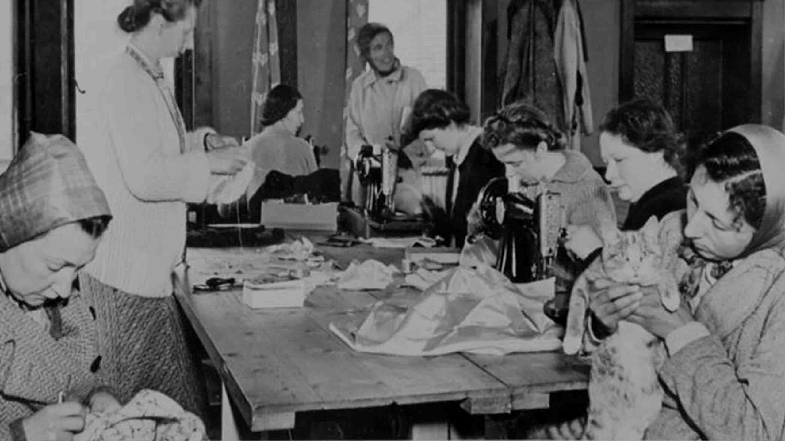 Women working in a glove-making industry at an internment camp on the Isle of Man during World War II.