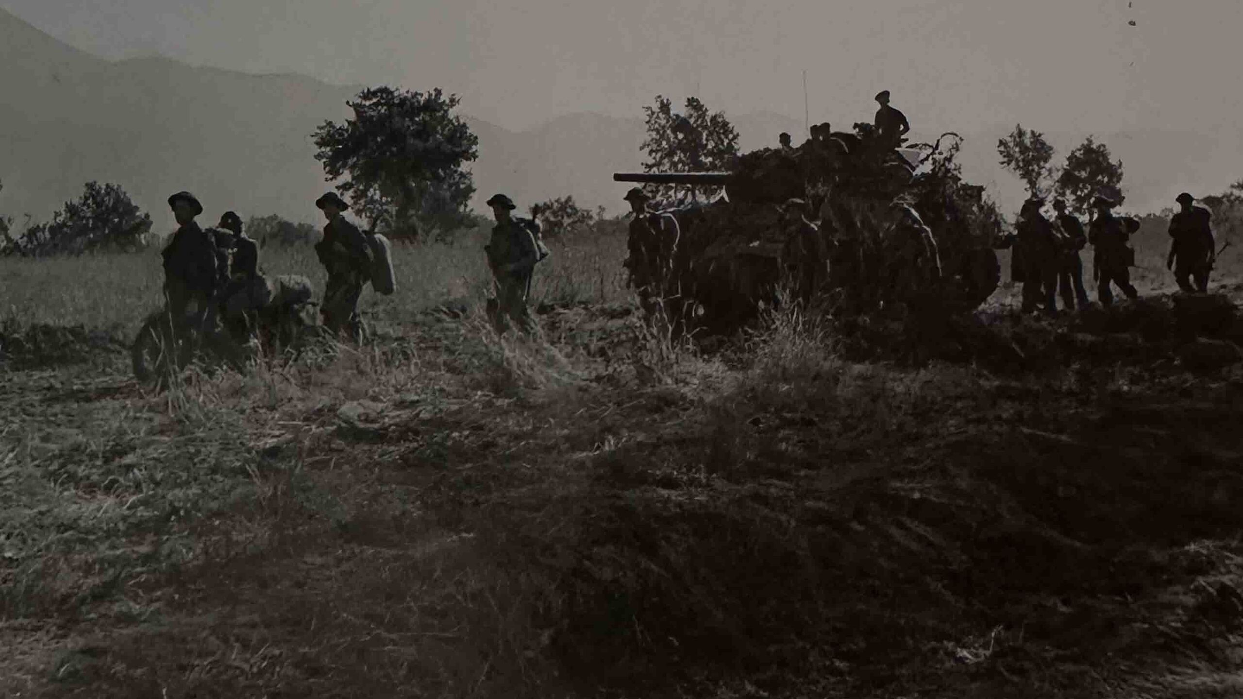 British soldiers and a sherman tank on the move in Italy, 1944.