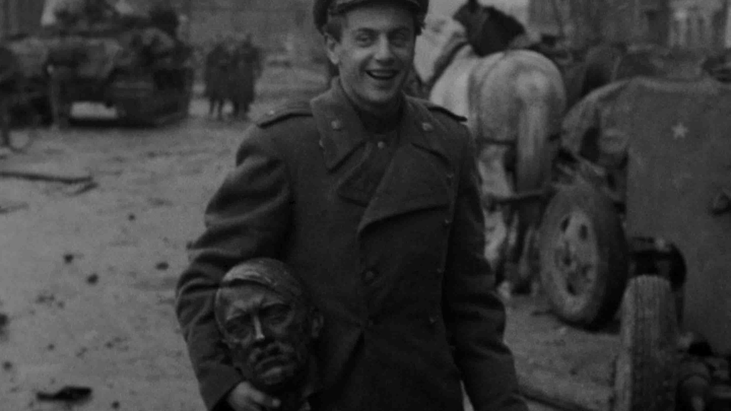 Soviet frontline poet and war correspondent Evgenii Dolmatovsky in Berlin, holding a captured statue head of Adolf Hitler as a war trophy. May 2, 1945.