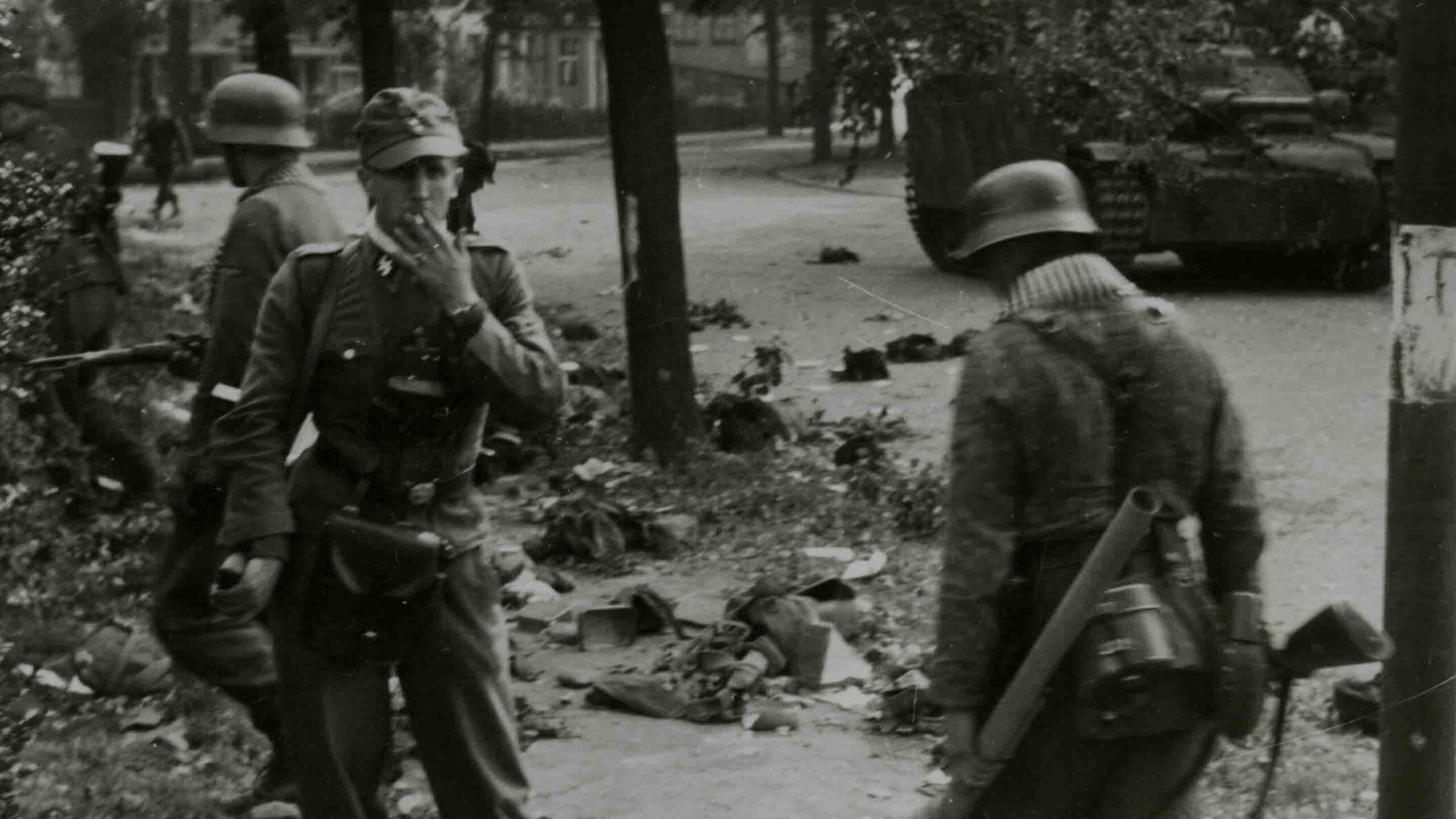 German soldiers search for equipment left behind after the battles on 17 September 1944. An SS officerlooks directly into the camera.