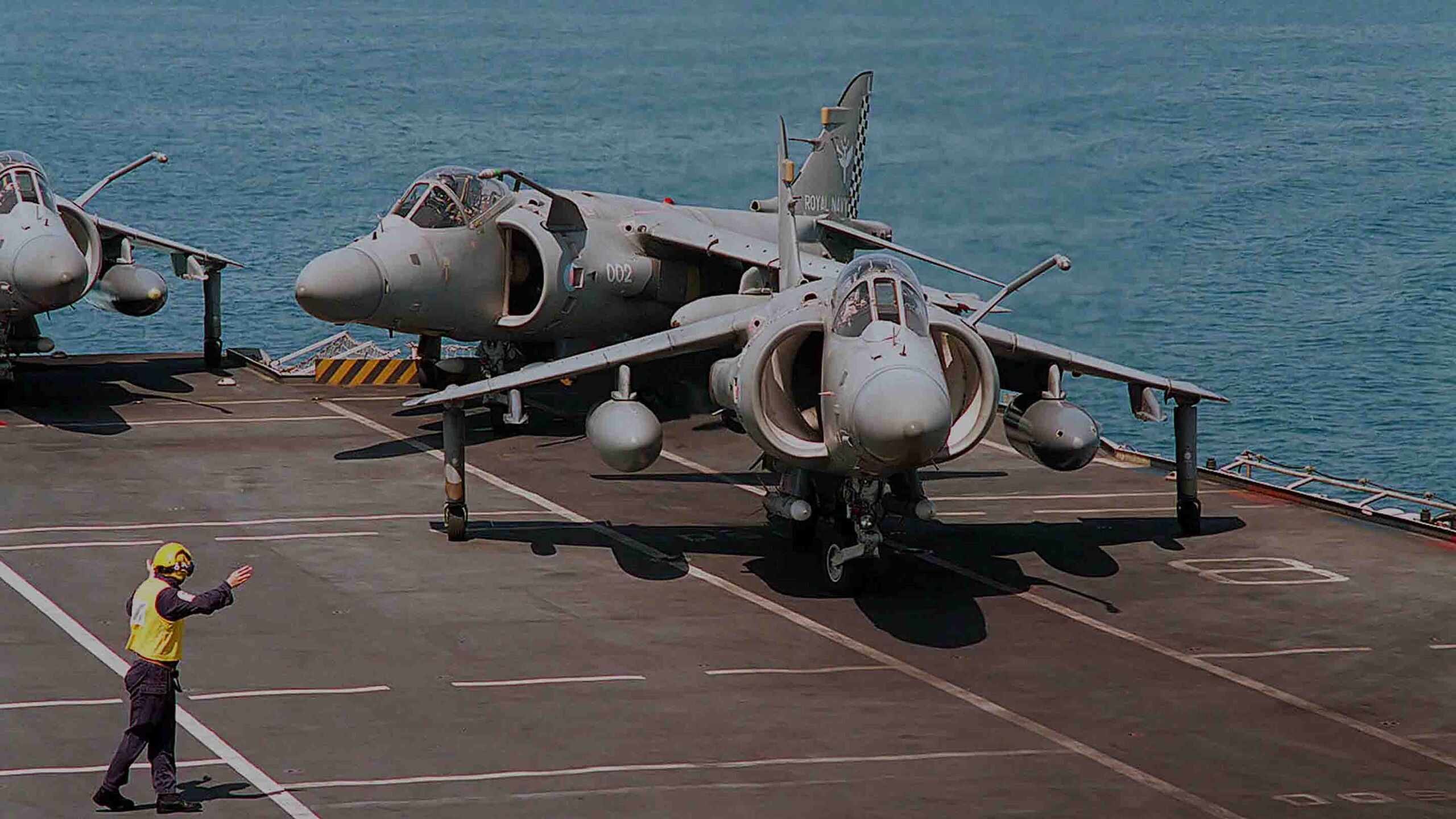 Royal Navy crewmen aboard HMS Illustrious (R06) prepare a BAe Sea Harrier FA2 from 801 Naval Air Squadron for takeoff in the Persian Gulf, 12 March 1998.