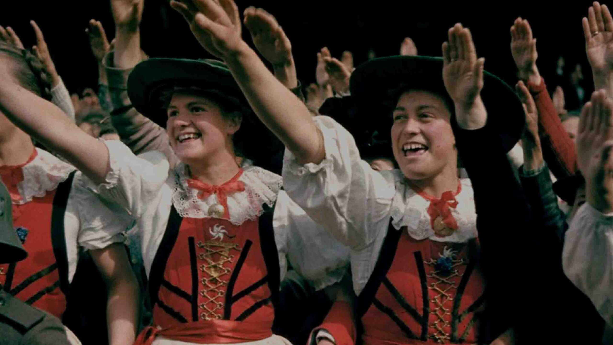 Young women of the BDM (Bund Deutscher Mädel) raise their arms in the Nazi salute. Date and location unknown.