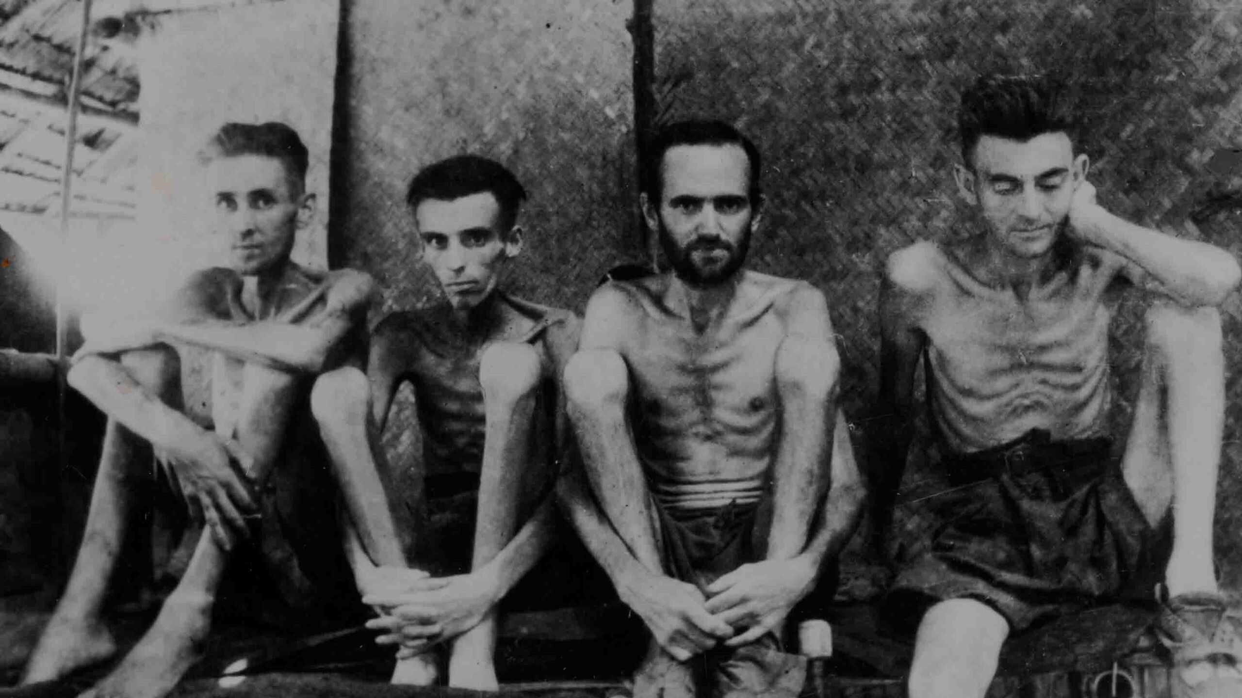 Prisoners in Changi Jail, Singapore, showing four skeletal soldiers.
