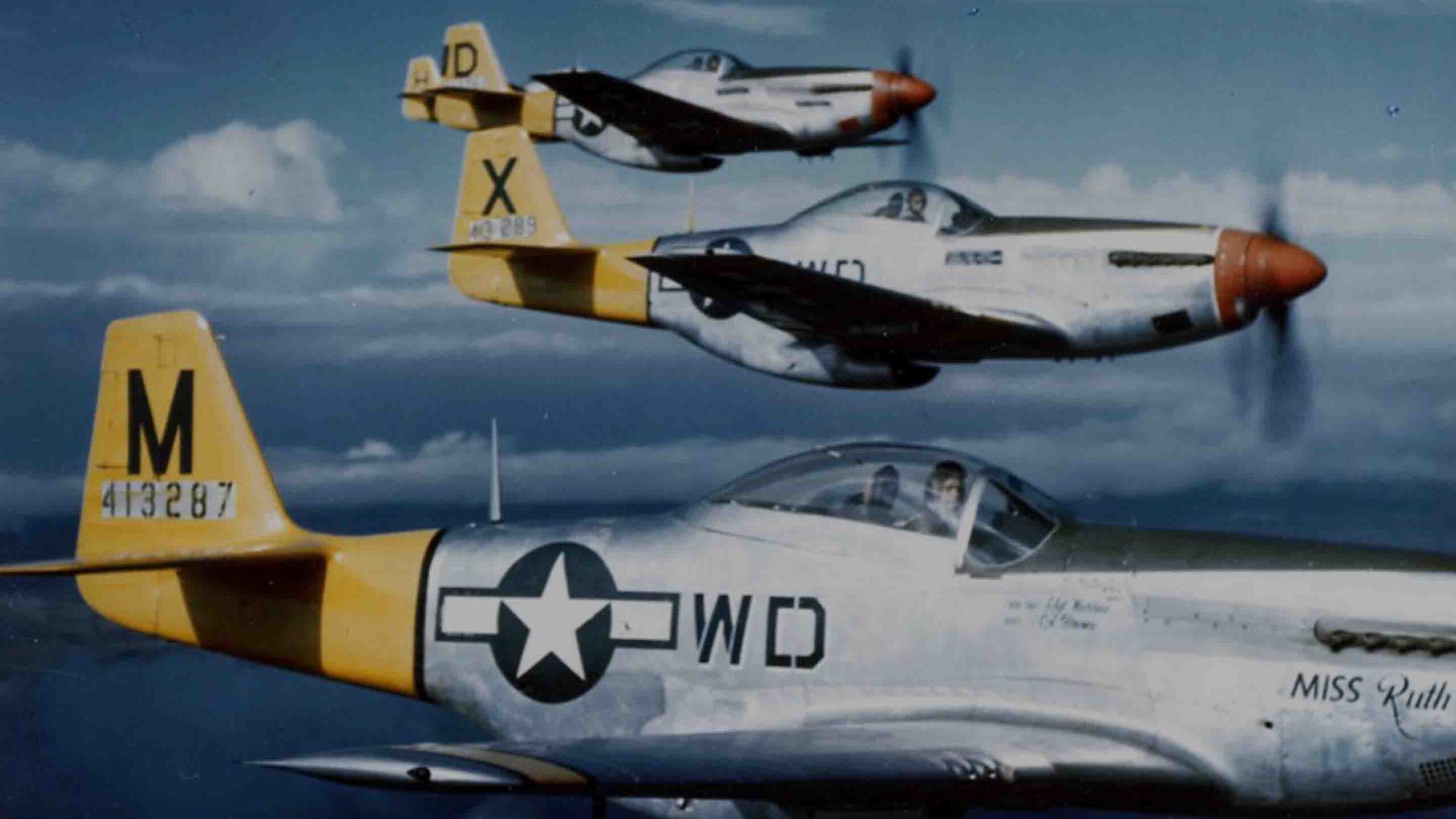 P-51D Mustangs of the 4th Fighter Squadron, 52nd Fighter Group, 15th Air Force in flight, August 1944. Lead aircraft: "Miss Ruth" (WD-M); third aircraft: "JO-BABY" (WD-D).