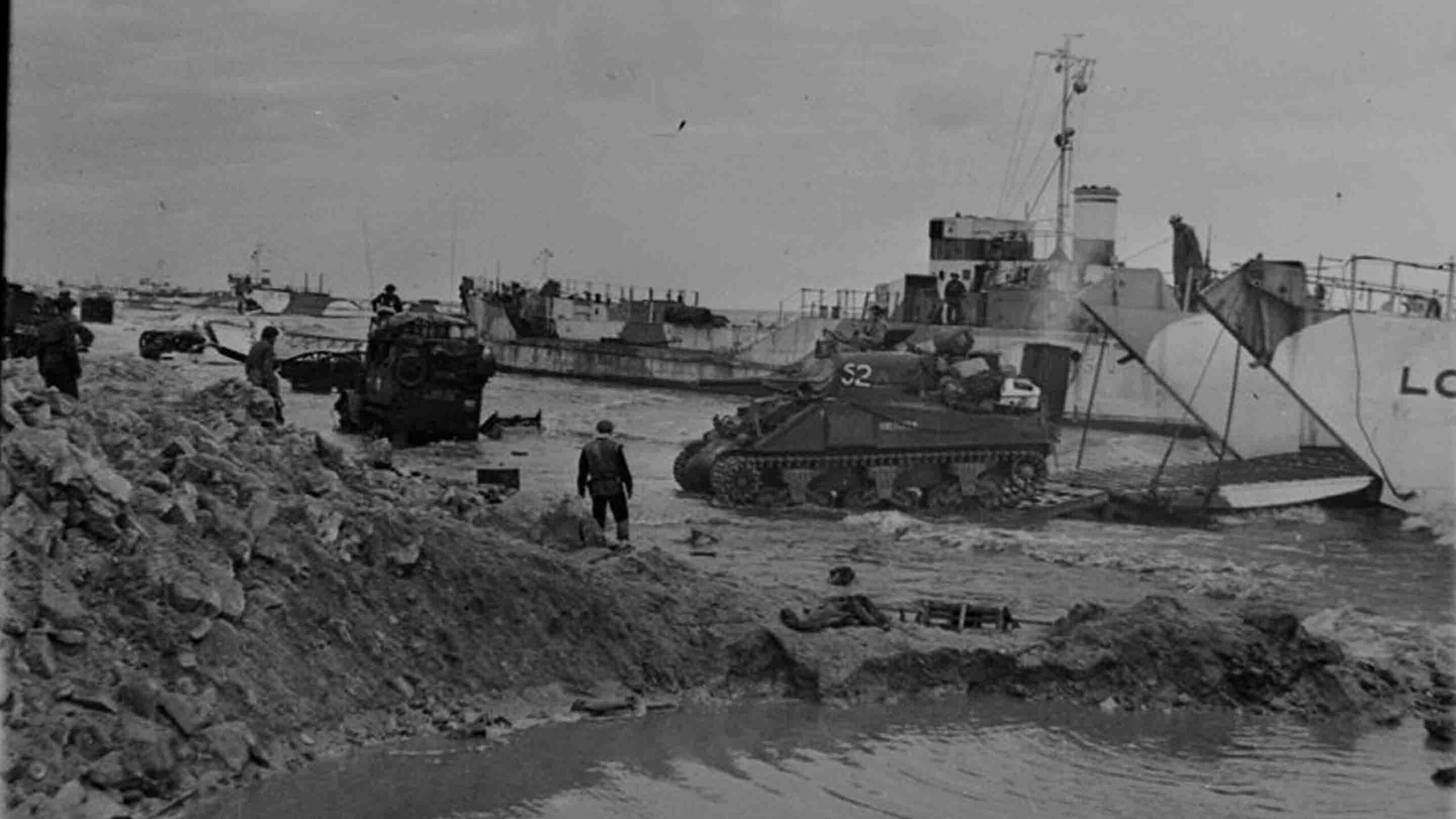 Sherwood Rangers Sherman tanks driving off the ramp of an LCT on Gold beach.
