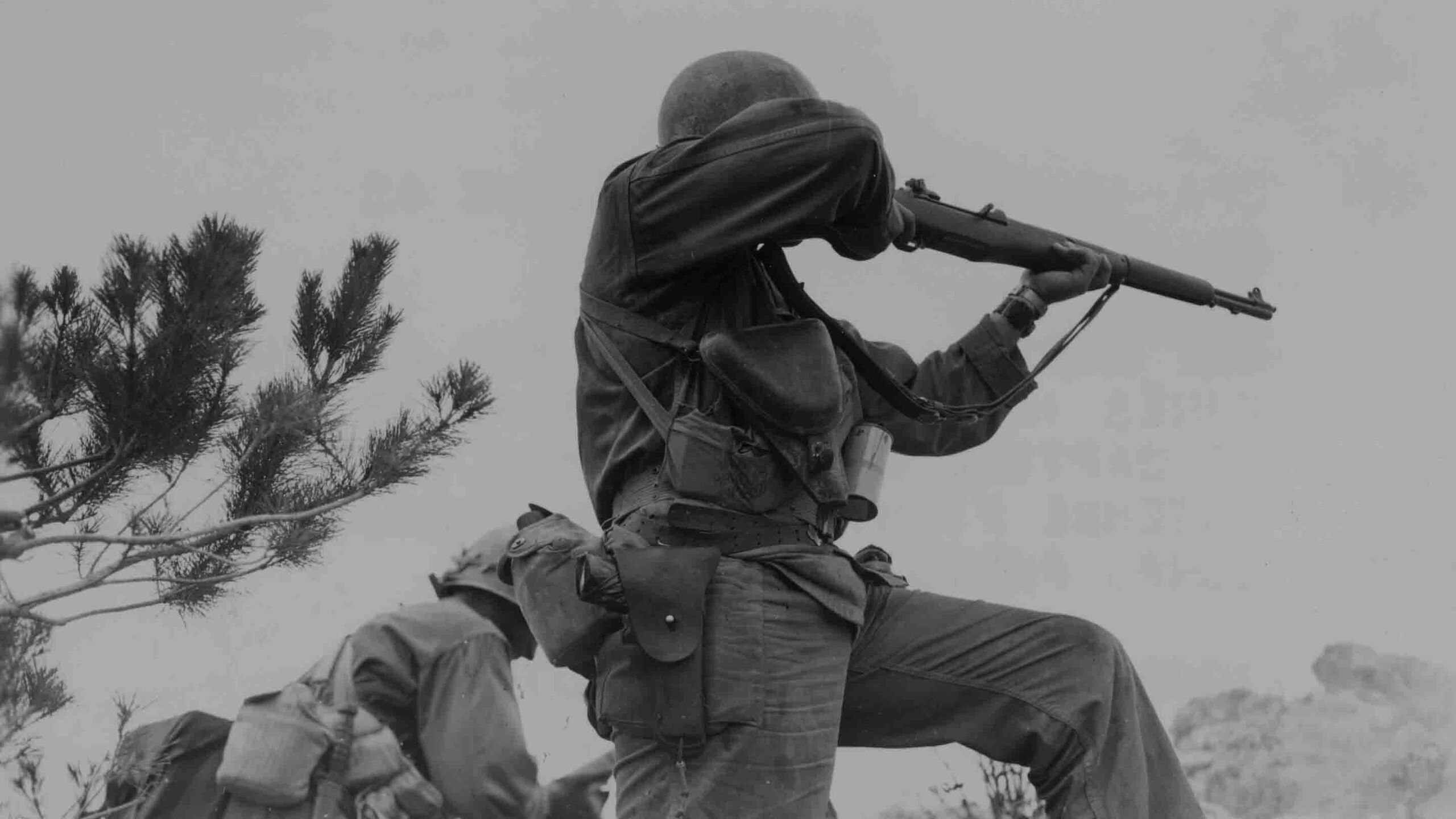 Two riflemen of the 96th Infantry Division engage in combat during the advance to capture Big Apple Hill on Okinawa, 9 June 1945.