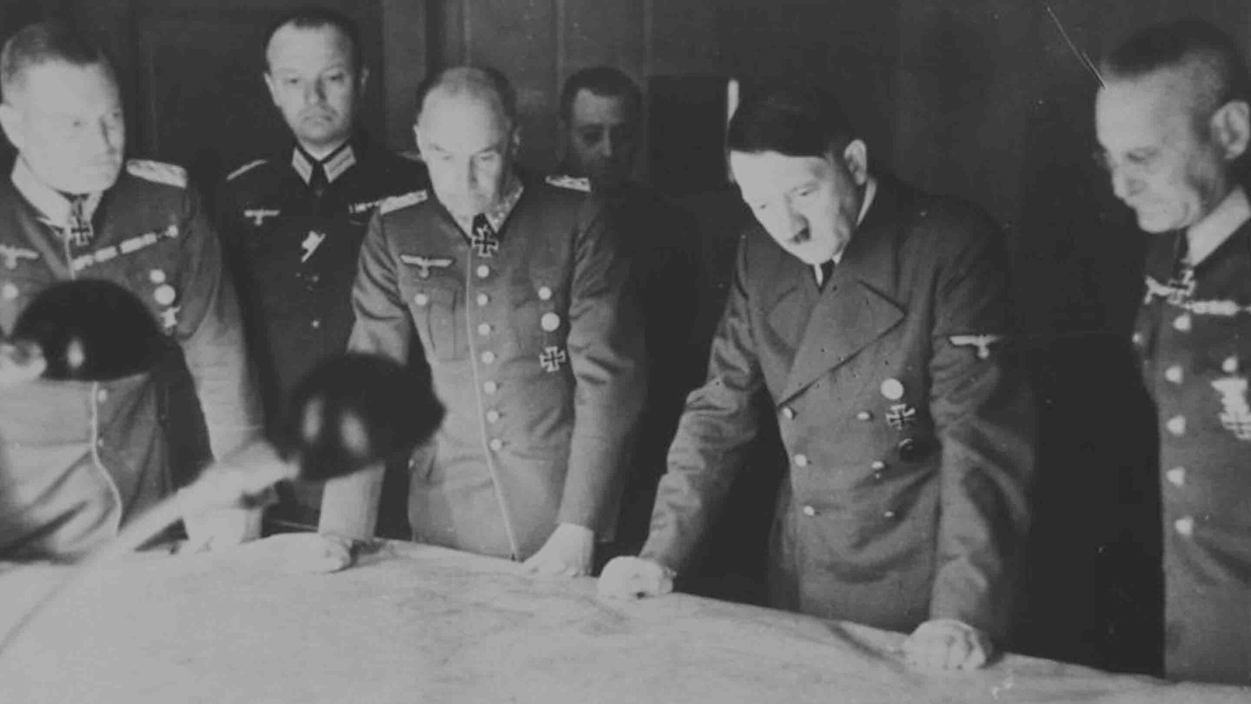 Adolf Hitler at the headquarters of Field Marshal Walther von Brauchitsch, alongside Field Marshal Wilhelm Keitel, Colonel General Franz Halder, and other senior military leaders. This meeting took place during Germany's early campaigns in World War II.