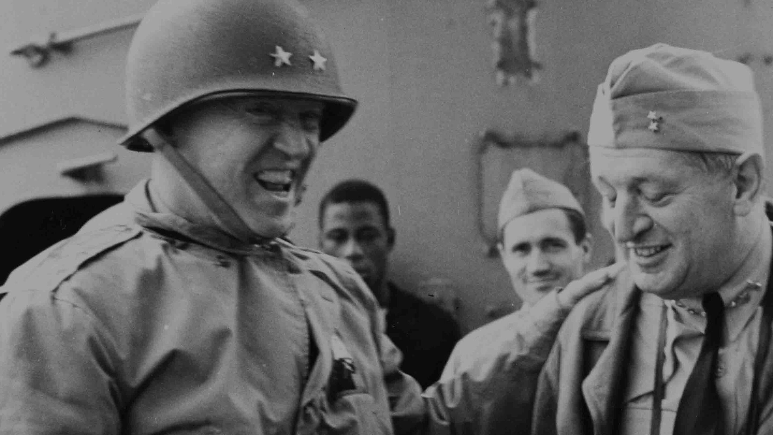 November 9, 1942: Major General George S. Patton, Jr. and Rear Admiral H. Kent Hewitt share a light moment aboard USS Augusta (CA-31) off Morocco during Operation Torch.